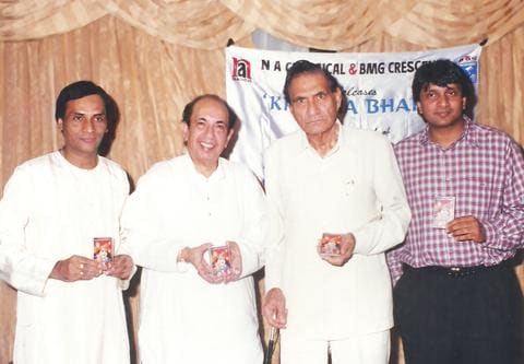 Four men holding cassettes at the Krishna Bhakti release, with the N A Classical and BMG Crescendo banner
