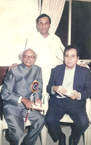 Naushad Ali and Dilip Kumar seated, with Kavi Narayan Agrawal standing behind them