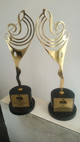 The two Clef Music Awards trophies, 2025: Devotional - Best Lyricist and Devotional - Best Album.